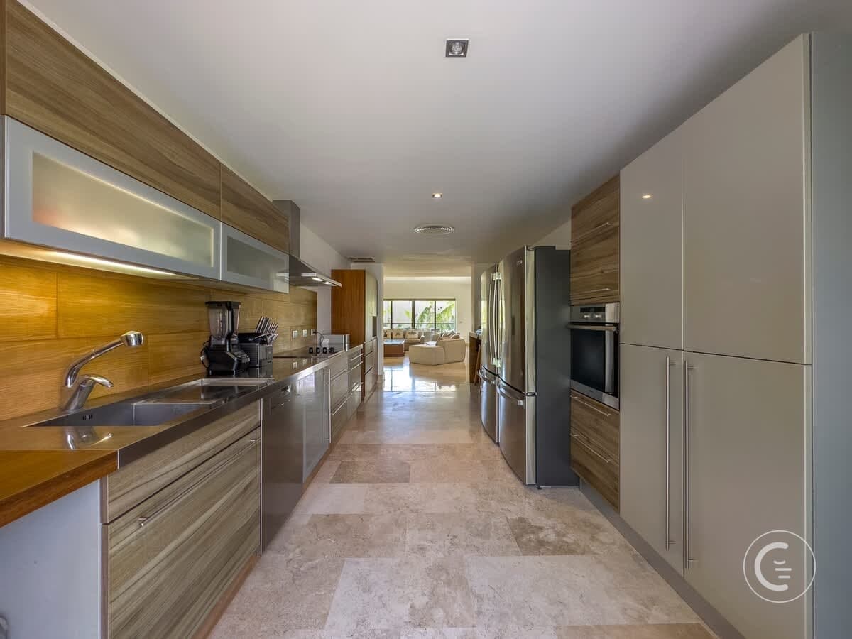 A modern kitchen with stainless steel appliances and wood cabinets.