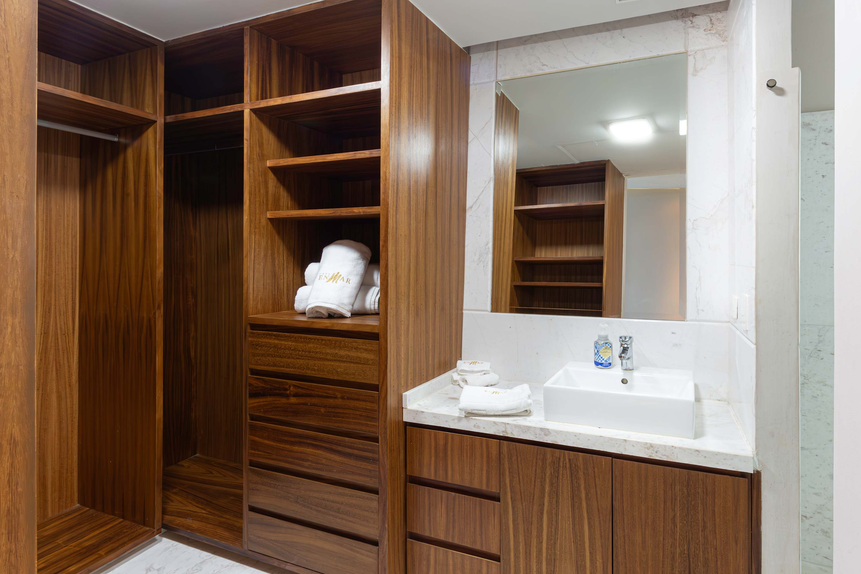 A wooden closet with shelves, drawers, and a sink is visible.