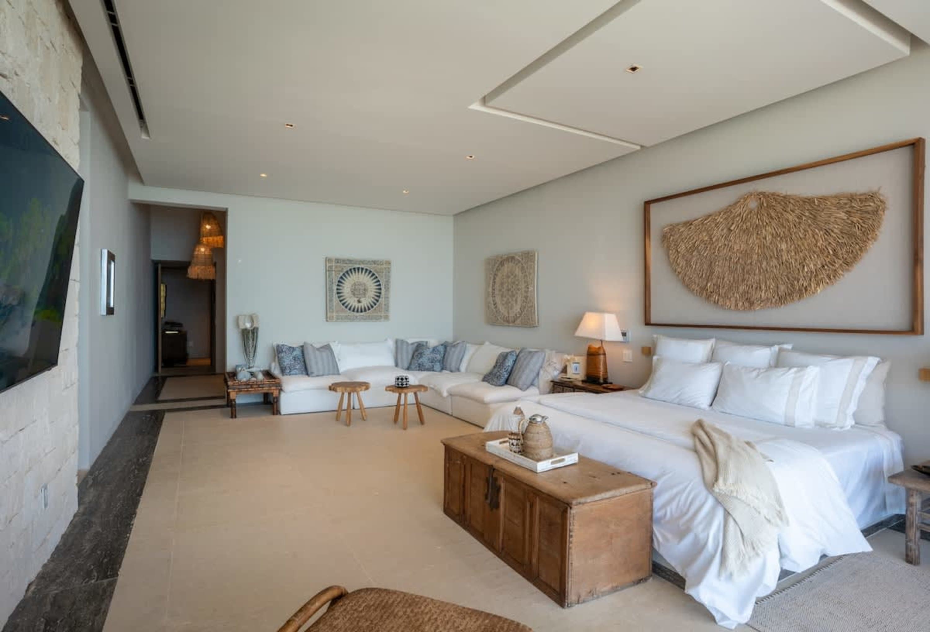 Bedroom with a large bed and a sectional sofa.