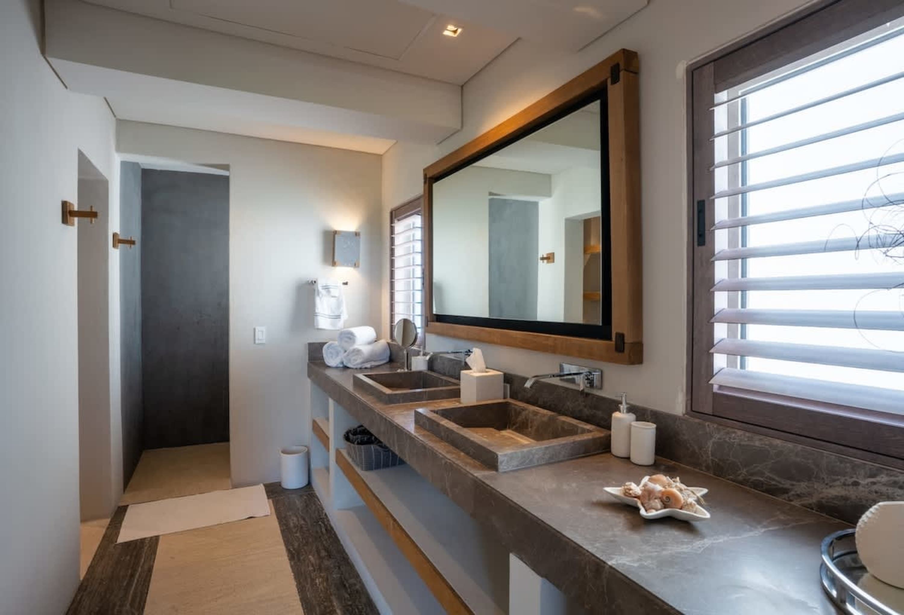 Luxury bathroom with double sinks, large mirror, and modern fixtures.