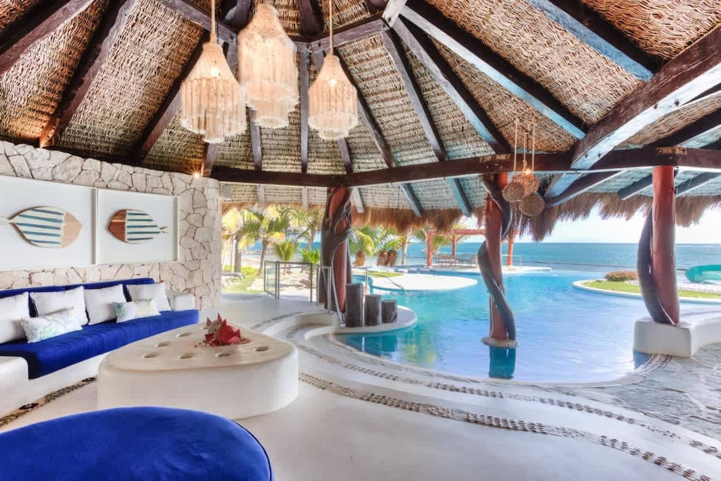 Luxury tropical cabana with an infinity pool overlooking the ocean.