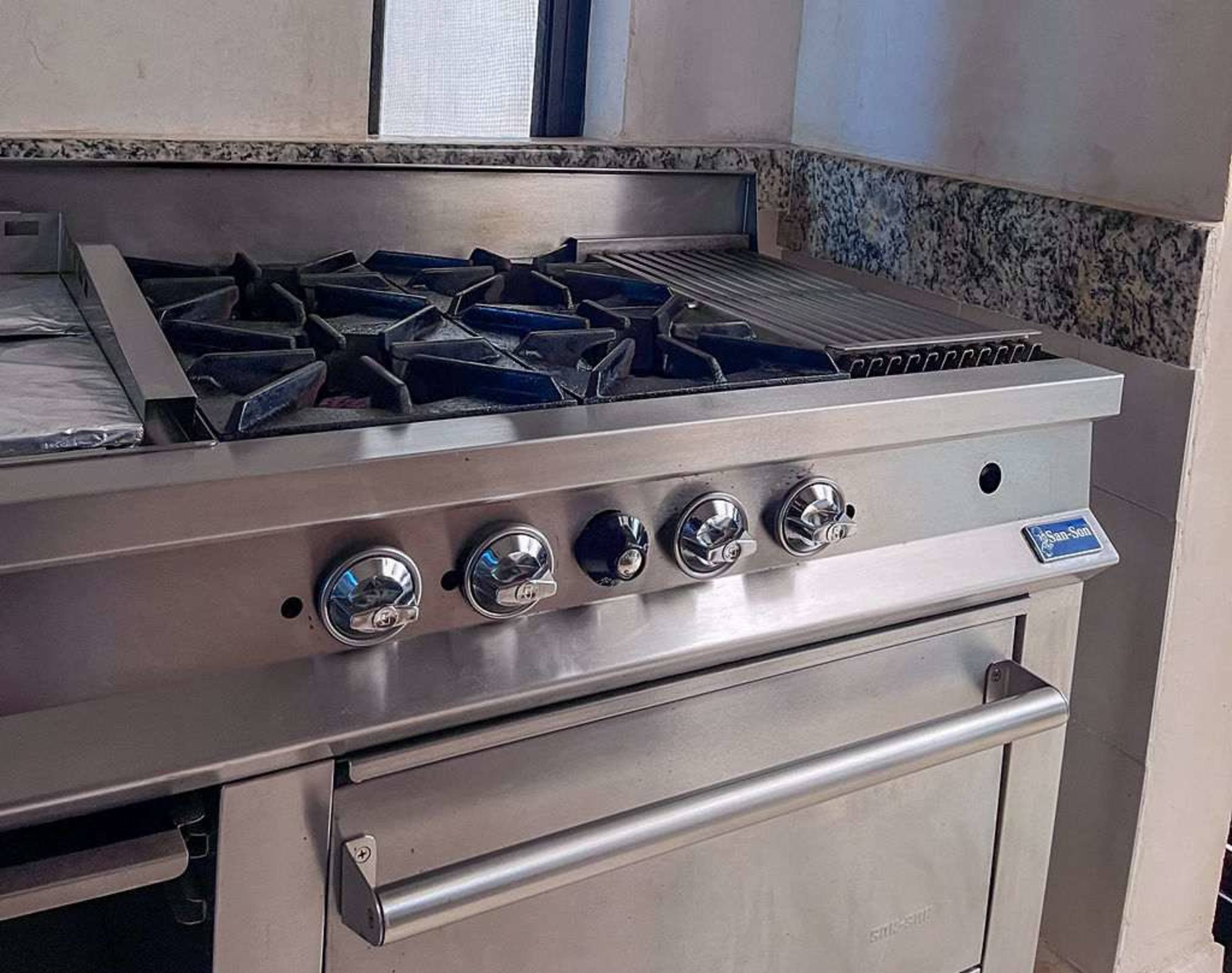 Professional stainless steel gas range with griddle.