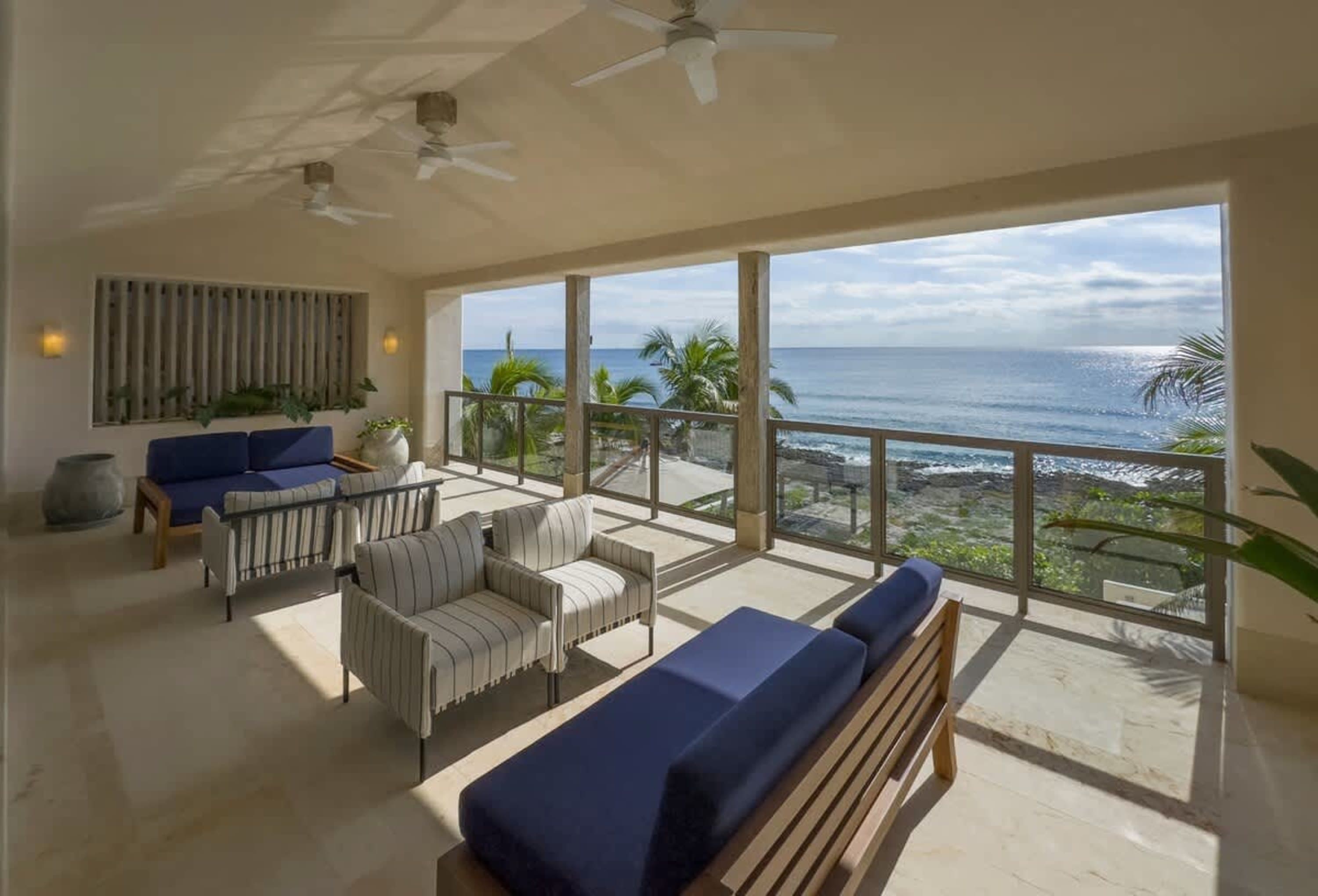 Beautiful patio furniture overlooks the ocean.