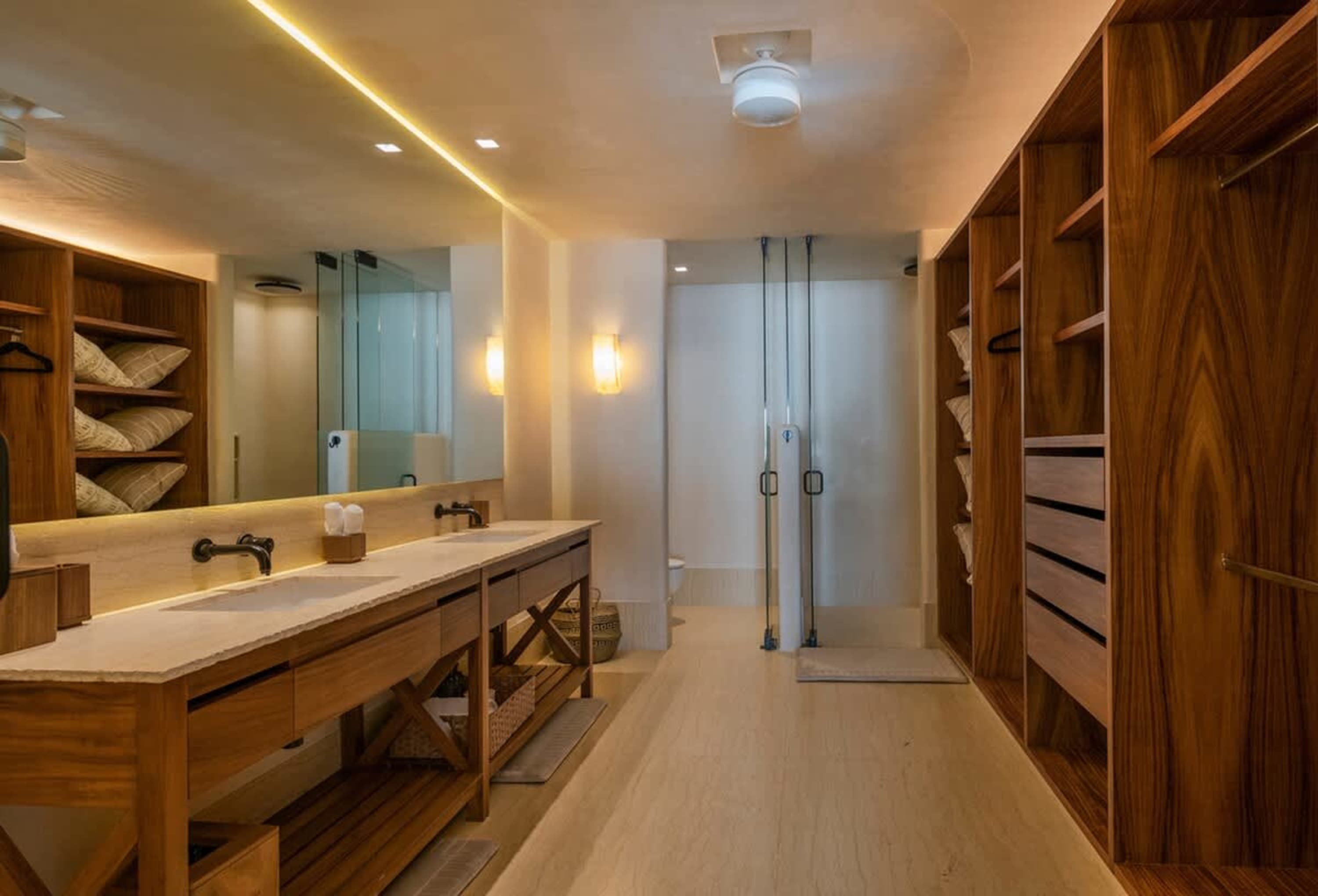 Modern bathroom with double vanity, walk-in closet, and shower.