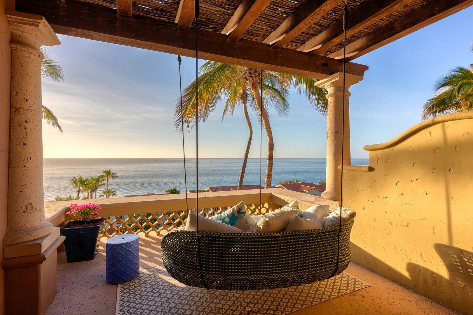 An outdoor swing on the balcony with an ocean view.