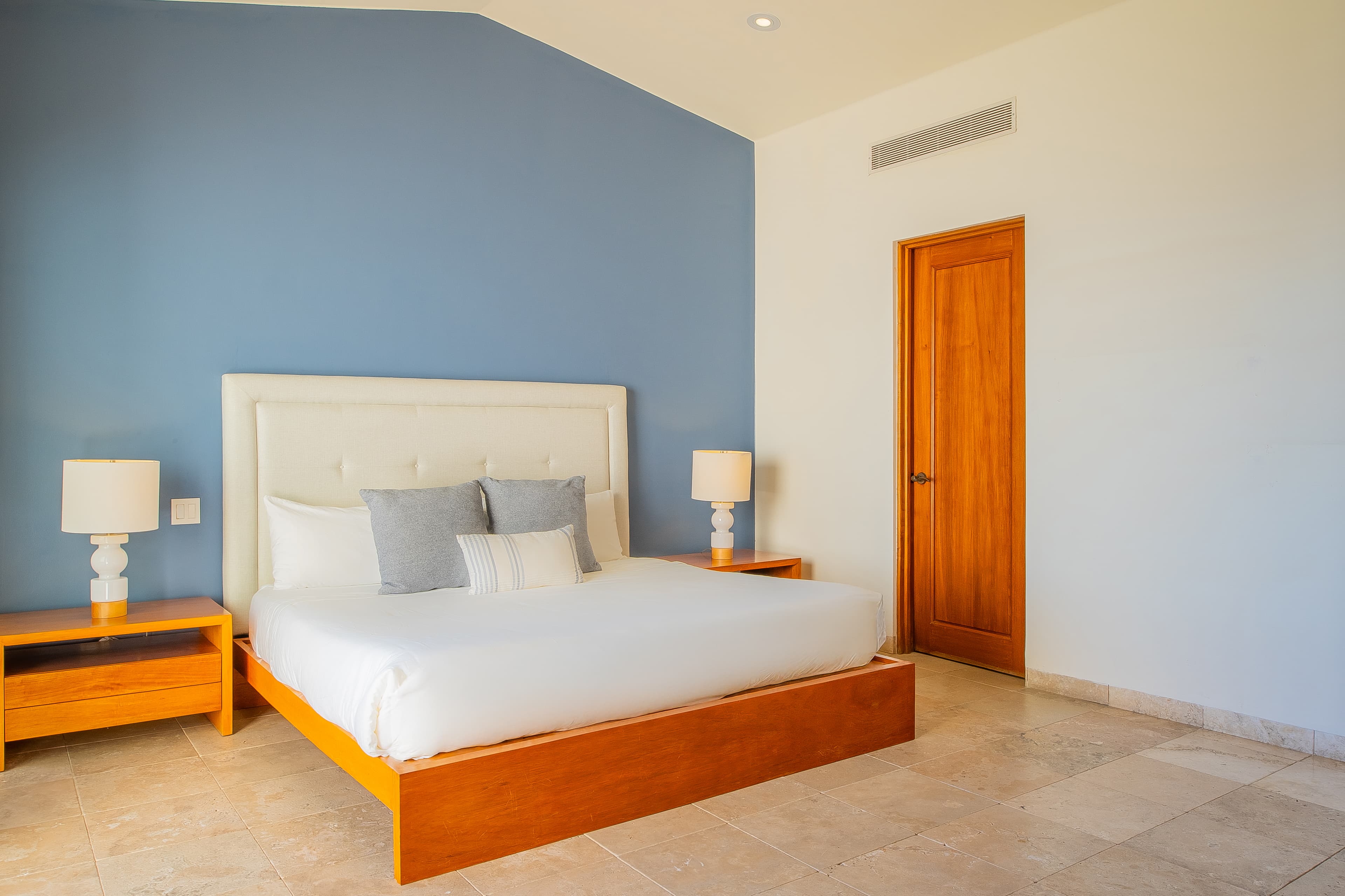 Bedroom 2 · Drift into restful sleep surrounded by calming coastal hues and premium linens. Your peaceful retreat features a plush bed, modern comfort, and gentle lighting to ensure rejuvenation.