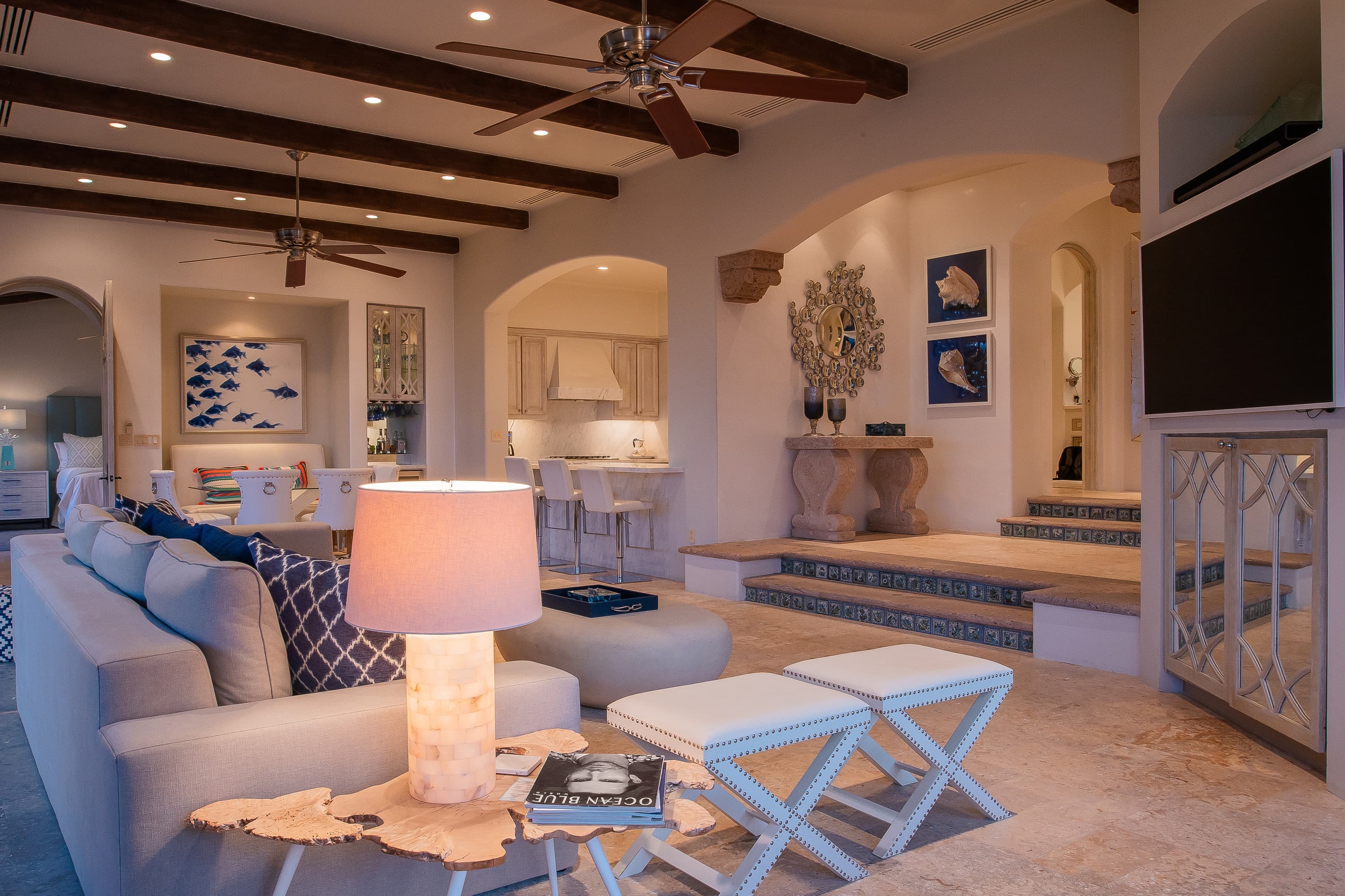 The main living area of this Los Cabos Luxury Vacation Villa, with a large couch and wall-mounted TV.