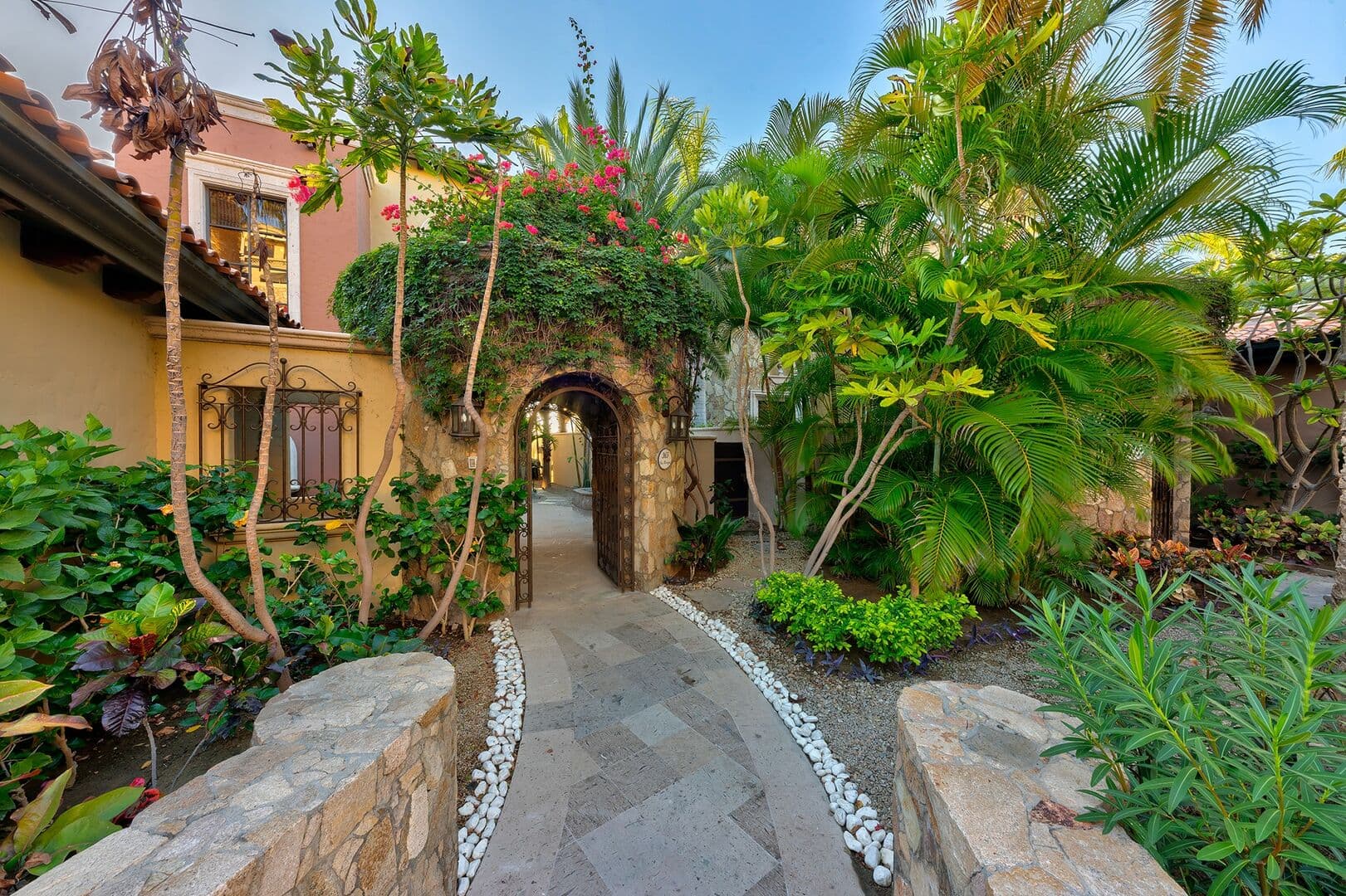 Front view of the Los Cabos villa, Pura Vida, with the large stone path leading to the front door.