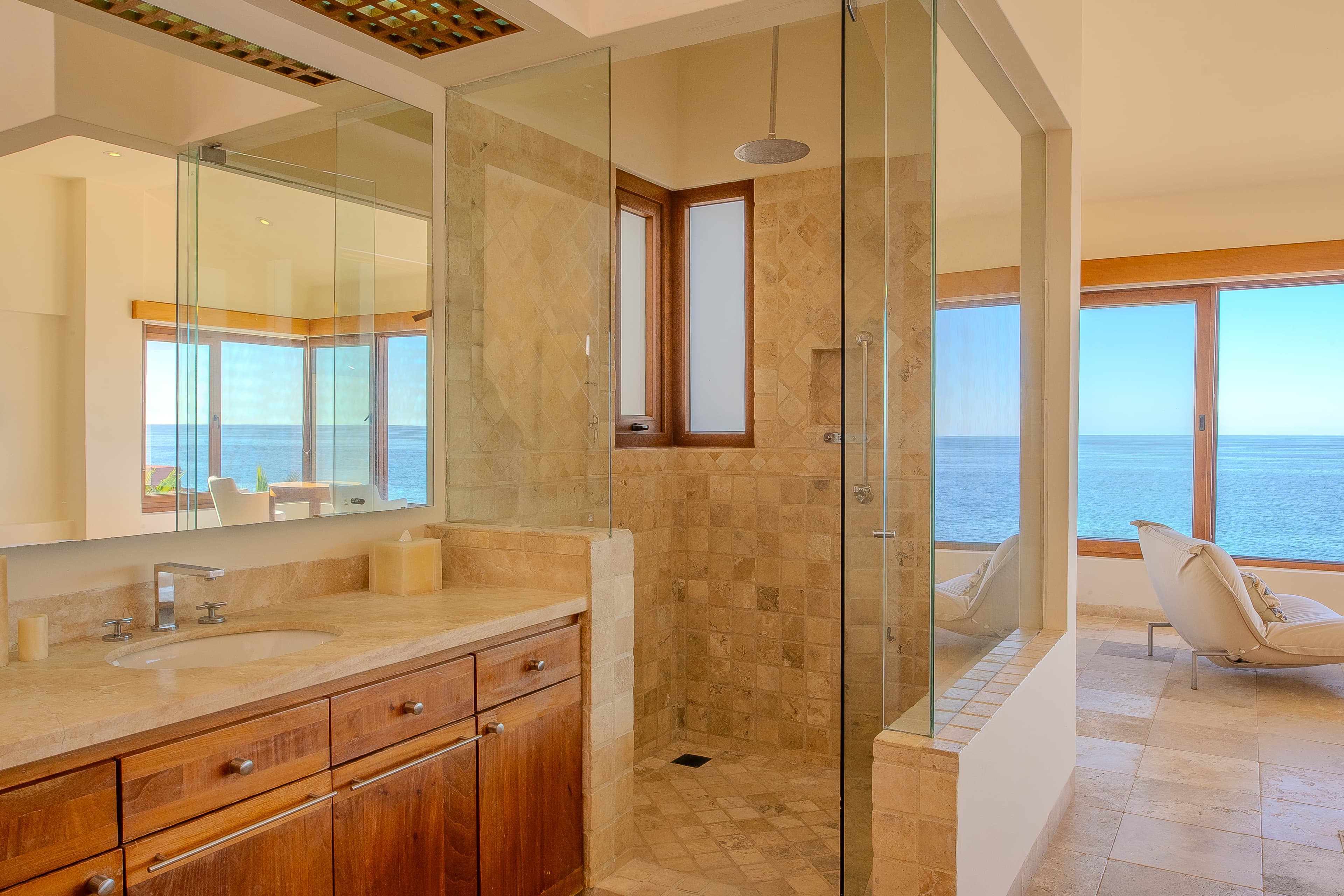 Bathroom 1 (Master ensuite) · Stunning sea views frame your private spa-like sanctuary, where sunlight pours through floor-to-ceiling windows and a spacious walk-in shower invites you to unwind.