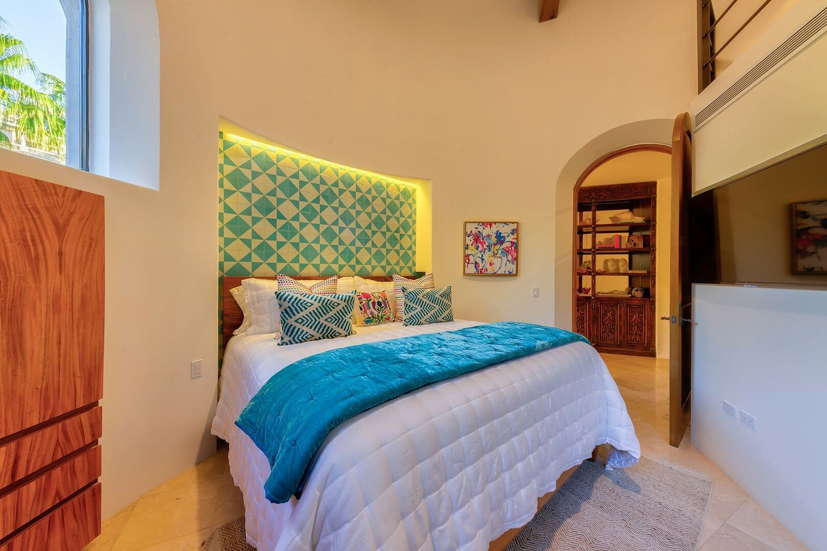 A third bedroom with a spiral staircase leading to a loft.