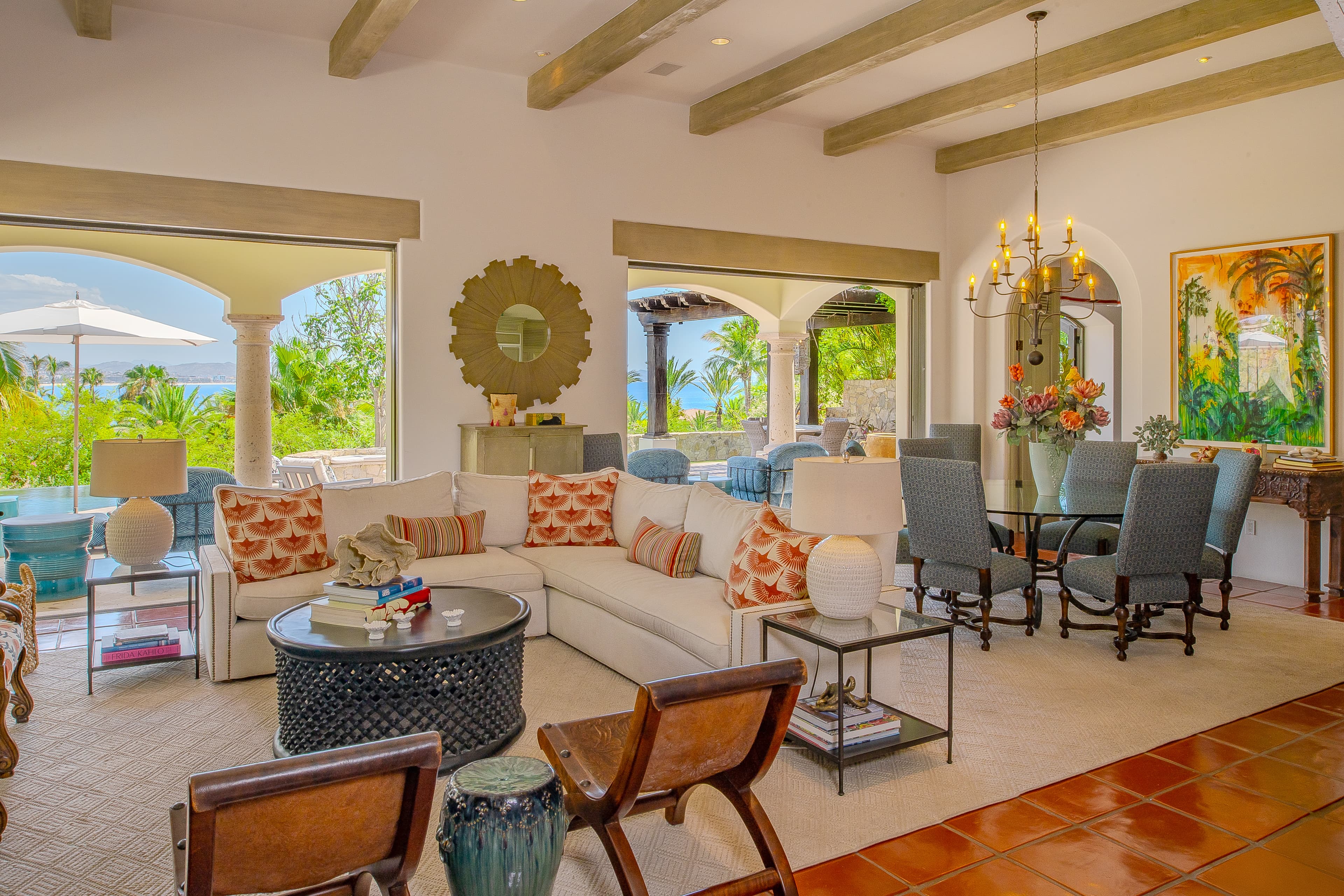 Sink into plush seating surrounded by vibrant decor and arched openings that frame lush tropical views, creating your perfect backdrop for morning coffee or sunset drinks.