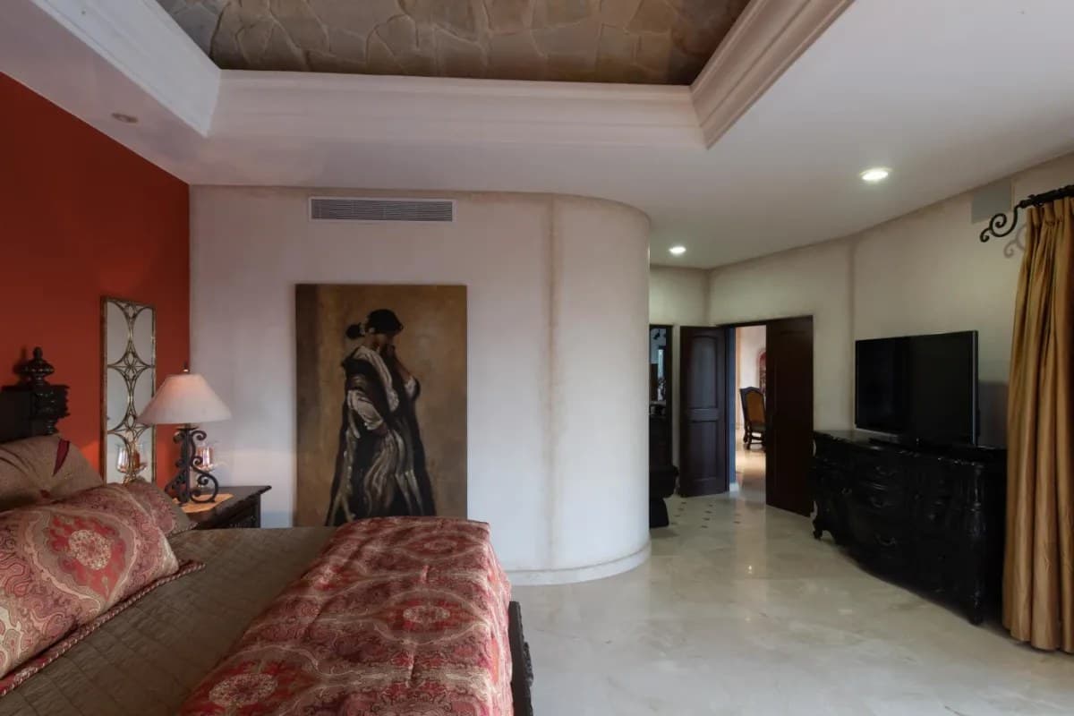 Bedroom 1 (Master) · Your spacious bedroom features rich accent walls, elegant furnishings, and modern comforts including air conditioning and a flat-screen TV to enhance your stay.