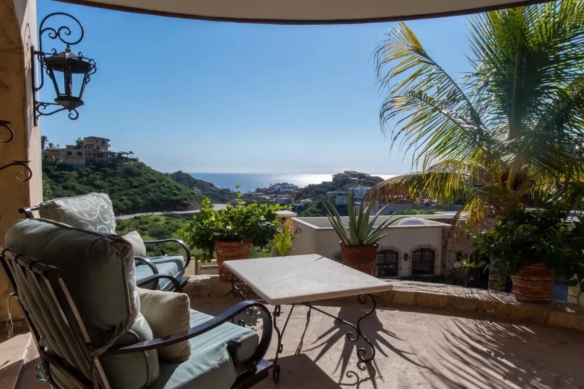 Relax on your private terrace overlooking hillside homes and sparkling ocean views, framed by tropical palms and coastal breezes—perfect for morning coffee or sunset unwind.