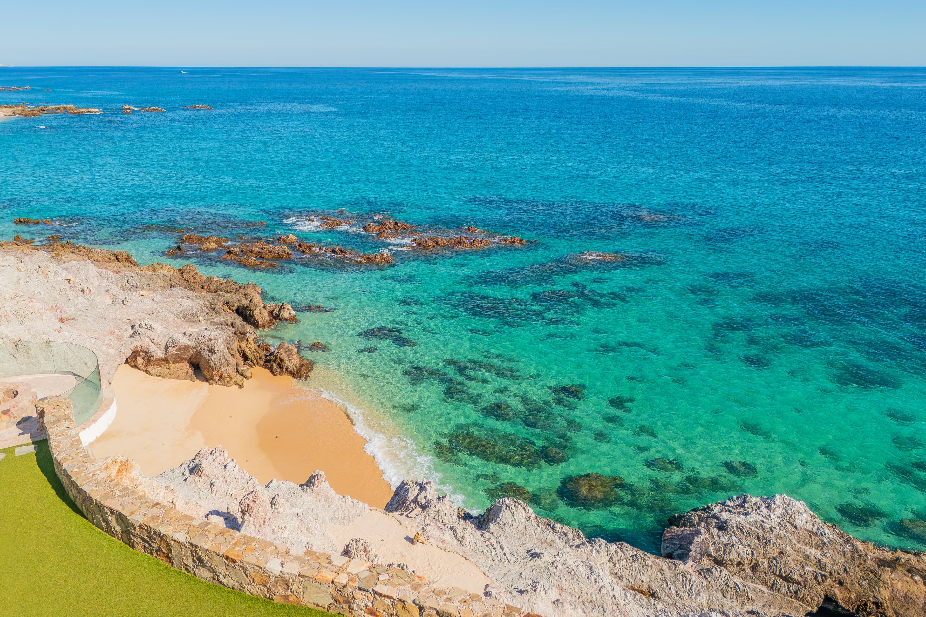Crystal-clear turquoise waters meet a secluded sandy cove, showcasing the pristine Mediterranean coastline that surrounds this stunning property—a dreamy backdrop to your coastal getaway.