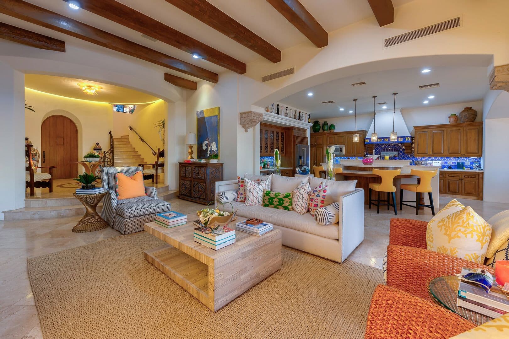 Another seating area next to the kitchen with multiple chairs and a custom coffee table.